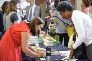 Erin Gruwell (left) signs autographs for Tuscaloosa City Schools' Colleen Ferguson (right) following her speech at Institute Day.